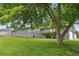 Charming single-story home with a well-maintained lawn and mature tree providing shade at 7155 E Exposition Ave, Denver, CO 80224