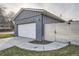 Contemporary two-car garage with brick facade, white door, and wooden fence at 7155 E Exposition Ave, Denver, CO 80224