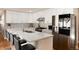 Stylish kitchen features white cabinets, quartz countertops, stainless appliances, and a peninsula with seating at 7155 E Exposition Ave, Denver, CO 80224
