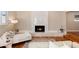 Bright living room features a modern fireplace with stylish tile and ample lighting at 7155 E Exposition Ave, Denver, CO 80224