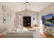 Bright living room featuring hardwood floors, vaulted ceilings, and stylish modern furnishings at 7155 E Exposition Ave, Denver, CO 80224