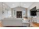 Cozy living room featuring hardwood floors, bright natural light and a modern entertainment center at 7155 E Exposition Ave, Denver, CO 80224