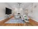 Bright living room with vaulted ceilings, fireplace, hardwood floors, and stylish decor at 7155 E Exposition Ave, Denver, CO 80224