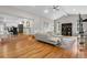 Open concept living room with hardwood floors seamlessly flows into the modern kitchen at 7155 E Exposition Ave, Denver, CO 80224