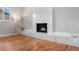 Bright living room featuring a modern fireplace, hardwood floors and recessed lighting at 7155 E Exposition Ave, Denver, CO 80224