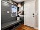 Mudroom with gray shiplap, storage bench, hooks, and convenient organization at 7155 E Exposition Ave, Denver, CO 80224