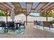 Outdoor patio features a pergola, dining area and comfortable seating, perfect for entertaining at 7155 E Exposition Ave, Denver, CO 80224