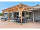 Charming patio featuring a pergola, dining area, and comfortable seating, perfect for outdoor gatherings at 7155 E Exposition Ave, Denver, CO 80224