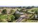 Aerial view of the house with a long driveway, a two-car garage, and surrounded by nature at 7388 S Ireland Cir, Centennial, CO 80016