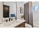Modern bathroom featuring vanity and shower with framed mirror and modern fixtures at 7388 S Ireland Cir, Centennial, CO 80016