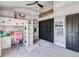 Bright bedroom features a loft bed, a pink chair, and unique striped walls and decor at 7388 S Ireland Cir, Centennial, CO 80016