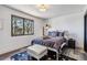 Stylish bedroom with a large window, a comfortable bed, and modern decor at 7388 S Ireland Cir, Centennial, CO 80016