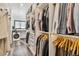 Spacious walk-in closet with custom shelving and a laundry area at 7388 S Ireland Cir, Centennial, CO 80016