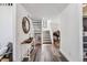 Inviting entryway with hardwood floors, staircase and a view of the piano room at 7388 S Ireland Cir, Centennial, CO 80016