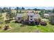 Exterior elevation with rear deck, hot tub and a playset, surrounded by trees at 7388 S Ireland Cir, Centennial, CO 80016