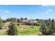 Exterior elevation of the home showcasing it's large lawn and mature trees at 7388 S Ireland Cir, Centennial, CO 80016
