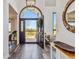 Inviting foyer with an arched doorway, a black door, and views of the landscape at 7388 S Ireland Cir, Centennial, CO 80016