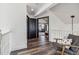 Hallway with a chair, modern lighting, wood floors and views into other rooms at 7388 S Ireland Cir, Centennial, CO 80016