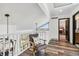 Hallway with a chair, modern lighting, wood floors and views into other rooms at 7388 S Ireland Cir, Centennial, CO 80016