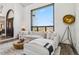 Comfortable living room featuring a large window, plush sectional sofa, round coffee table, and modern lighting at 7388 S Ireland Cir, Centennial, CO 80016