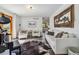 Bright living room featuring a piano, a white sofa, and mountain themed decor at 7388 S Ireland Cir, Centennial, CO 80016