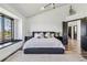 Bright main bedroom with a large window, a dark frame, and comfortable bed at 7388 S Ireland Cir, Centennial, CO 80016