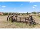 Rustic wagon sits in a field, adding character to this home's landscape at 7388 S Ireland Cir, Centennial, CO 80016