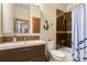 Modern bathroom featuring a mosaic tile backsplash, dark wood vanity and shower with a patterned blue curtain at 209 American Way, Breckenridge, CO 80424