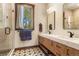 Modern bathroom with double sinks, decorative tile floor, and glass shower with wood trimmed window at 209 American Way, Breckenridge, CO 80424