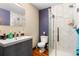 Modern bathroom with a glass-enclosed shower, gray vanity, hexagon tile and modern fixtures at 209 American Way, Breckenridge, CO 80424
