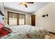 Bright bedroom features a unique blue accent wall, wood-trimmed windows, hardwood floors and stylish ceiling fan at 209 American Way, Breckenridge, CO 80424