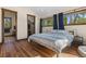 Bedroom featuring an open closet and two large windows showcasing the beautiful outdoors at 209 American Way, Breckenridge, CO 80424