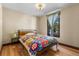 Comfortable bedroom with beautiful hardwood floors, a bright window and a modern wooden bed frame at 209 American Way, Breckenridge, CO 80424