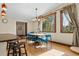 Well-lit dining area with wood floors, chandelier and large windows at 209 American Way, Breckenridge, CO 80424