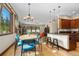 Bright dining area features wood floors, modern chandelier, and adjoins kitchen at 209 American Way, Breckenridge, CO 80424
