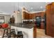Well-lit kitchen featuring a breakfast bar with modern lighting and wood cabinetry at 209 American Way, Breckenridge, CO 80424