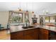 Open kitchen featuring wood cabinets, stone countertops and breakfast nook with backyard views at 209 American Way, Breckenridge, CO 80424