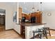 A well-lit kitchen with wood cabinets, black appliances and a convenient breakfast bar at 209 American Way, Breckenridge, CO 80424