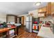 Studio kitchen with white counters, wood floors, stainless steel appliances and a view of the bedroom at 209 American Way, Breckenridge, CO 80424