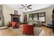 Cozy living room featuring a stone fireplace, ceiling fan, and natural lighting at 209 American Way, Breckenridge, CO 80424