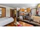 Inviting open floor plan with a comfortable leather sofa and a wood-burning fireplace and kitchenette at 209 American Way, Breckenridge, CO 80424