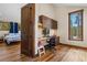 Well-lit office area with an adjustable desk, built-in shelves, and a scenic view of the outdoors at 209 American Way, Breckenridge, CO 80424