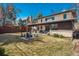 Large backyard showcasing a covered patio, outdoor dining area, firepit, and lush lawn at 424 Grape St, Denver, CO 80220