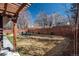 Fenced backyard with lush grass, a charming pergola, and comfortable outdoor seating by a firepit at 424 Grape St, Denver, CO 80220