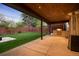 This backyard features a covered patio, a stone fireplace, and green grass at 424 Grape St, Denver, CO 80220