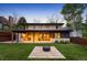 Beautiful backyard with patio, outdoor kitchen, fireplace, and manicured lawn at 424 Grape St, Denver, CO 80220
