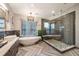 A luxurious bathroom features a soaking tub, walk-in shower, double vanity, and modern fixtures at 424 Grape St, Denver, CO 80220