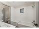 Bright bathroom featuring textured tile walls, modern fixtures, and a bathtub with a built-in seat at 424 Grape St, Denver, CO 80220