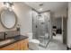 Modern bathroom with glass shower, unique sink fixture, and neutral color palette at 424 Grape St, Denver, CO 80220