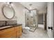 Modern bathroom featuring walk-in glass shower, sleek fixtures, and granite countertop at 424 Grape St, Denver, CO 80220